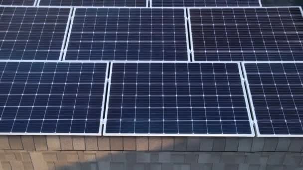 Aerial drone shot of photovoltaic solar panels on the roof of a building for renewable energy. Aerial shot of modules or solar panels along a roof. — Stock Video