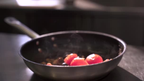 Frying vegetables on pan. The cook fries tomatoes on kitchen in restaurant. — Stock Video