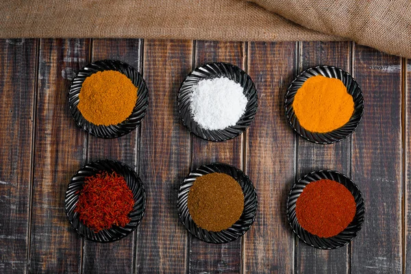 Various spices selection Saffron, turmeric, curry. different dry spices on a wooden background. — Stock Photo, Image