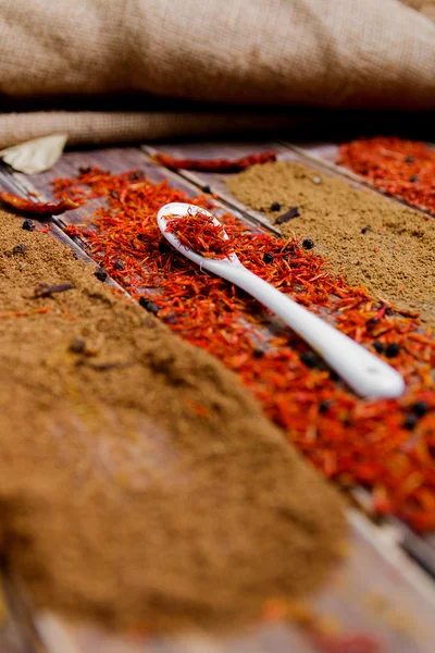 Various spices selection Saffron, turmeric, curry. different dry spices on a wooden background. — Stock Photo, Image