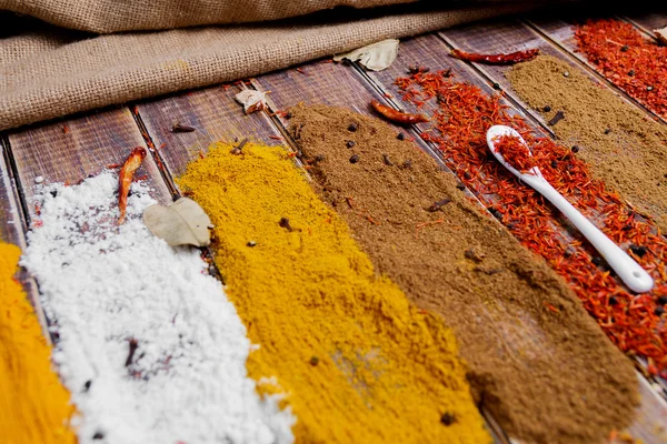 Various spices selection Saffron, turmeric, curry. different dry spices on a wooden background. — Stock Photo, Image