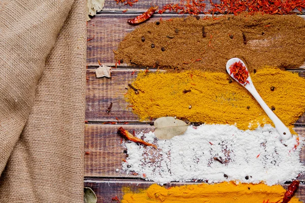 Various spices selection Saffron, turmeric, curry. different dry spices on a wooden background. — Stock Photo, Image