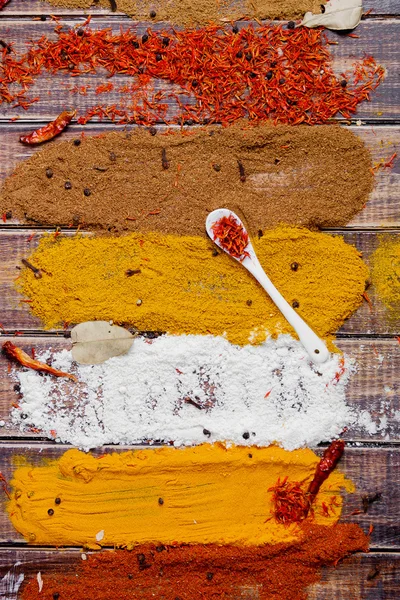 Various spices selection Saffron, turmeric, curry. different dry spices on a wooden background. — Stock Photo, Image