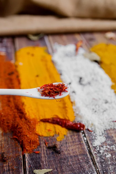 stock image Various spices selection Saffron, turmeric, curry. different dry spices on a wooden background.
