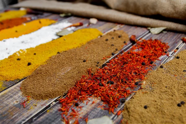 Various spices selection Saffron, turmeric, curry. different dry spices on a wooden background. — Stock Photo, Image