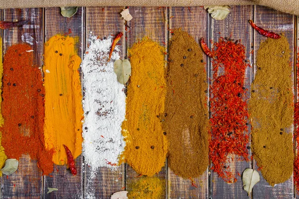 Various spices selection Saffron, turmeric, curry. different dry spices on a wooden background.