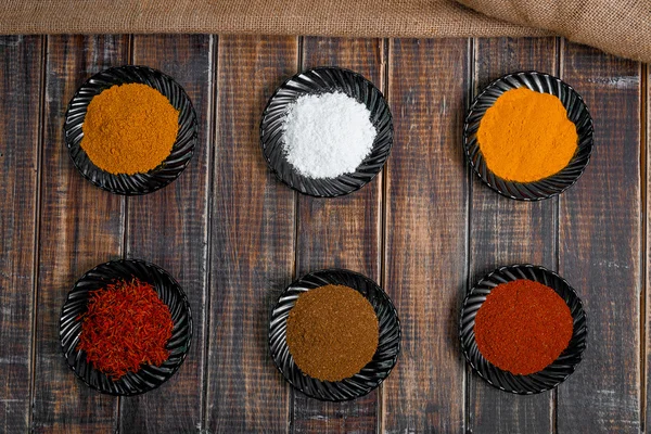 Various spices selection Saffron, turmeric, curry. different dry spices on a wooden background. — Stock Photo, Image