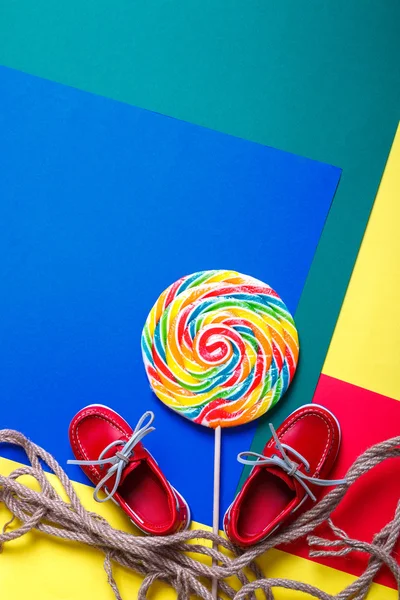 Small red boat shoes and lollipop