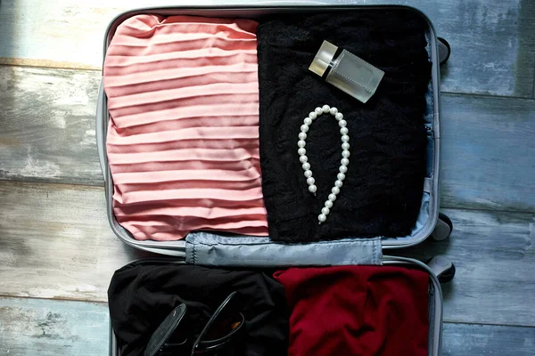 Packing suitcase at home with woman items, accessories — Stock Photo, Image