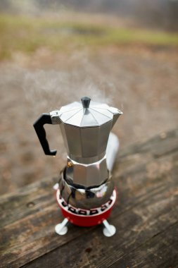 Metal gayzer kahve makinesiyle, gaz ocağında adım adım kamp kahvesi yapma süreci.