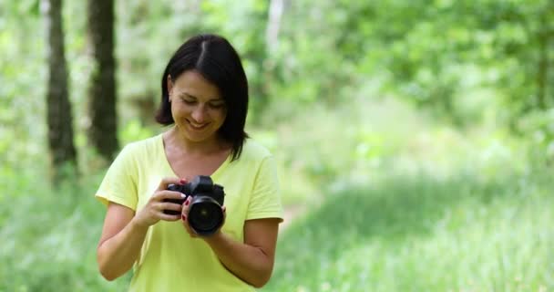 Fotógrafa femenina tomar una foto con una cámara profesional al aire libre, — Vídeo de stock