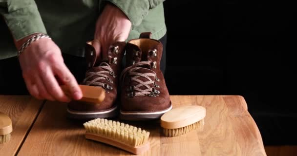 Man Hand Clean Suede Shoes Boots Brush Wooden Background Footwear — Stock Video