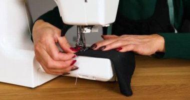 Adım adım, 50 yaşındaki yaşlı kadın dikiş makinesine kıyafet dikiyor atölye, tekstil endüstrisi, hobi, çalışma alanı ile çalışan olgun bir terzi. Oluşturma süreci DIY, Terzinin İş Yeri.