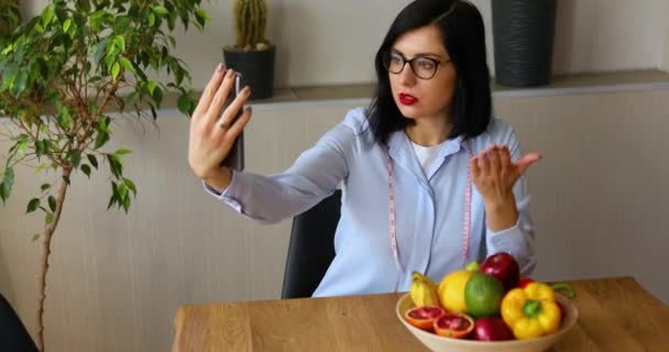 营养学家 营养学家 在智能手机上记录她关于健康饮食 保健和饮食概念的博客 有水果在家中工作的女营养师 — 图库视频影像