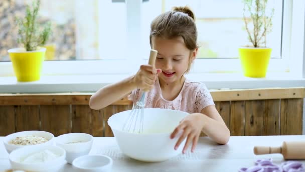 7歳の女子高生料理でザキッチン カジュアルなライフスタイル 小さな女の子ヘルプ焼く — ストック動画