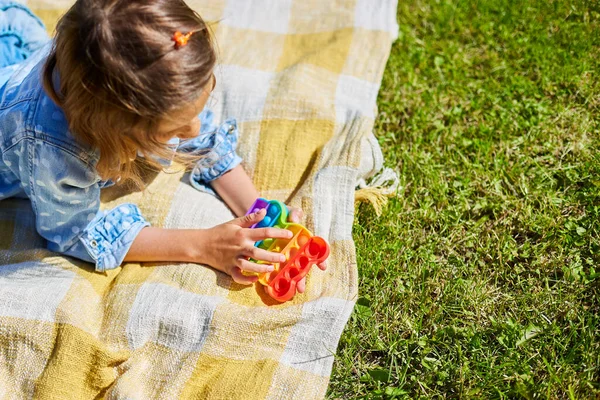 Girl Lies Blanket Grass Outdoors Play Pop Kid Hands Playing — Stock Photo, Image