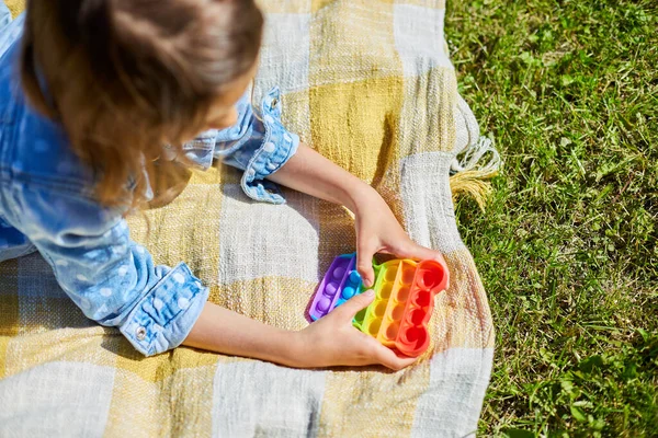 Girl Lies Blanket Grass Outdoors Play Pop Kid Hands Playing — Stock Photo, Image