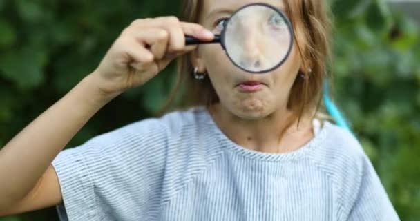 Niña Jugando Con Una Lupa Patio Trasero Hacer Caras Concepto — Vídeo de stock