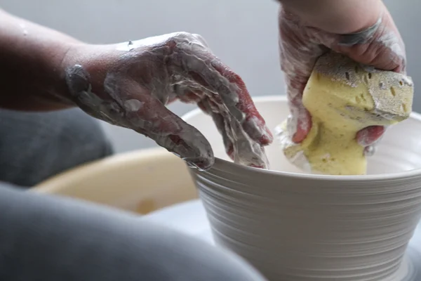 Hands of potter on potters wheel — Stock Photo, Image