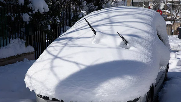 Beautiful winter morning snow covered car on the street of Athens, Greece, 16th of February 2021.