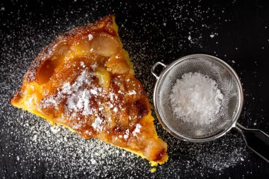 Pudra şekerli bir dilim elmalı pasta.