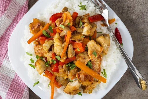 Tavuklu pilav ve diğer sebzeler tabakta.