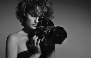 Black and white photo of beautiful woman with photo camera