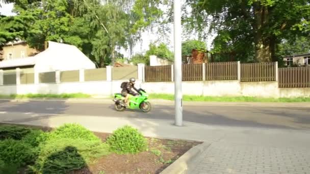 Μοτοσικλέτα πράσινο ποδήλατο ιππασία πηγαίνει κατά μήκος οδών πόλης — Αρχείο Βίντεο