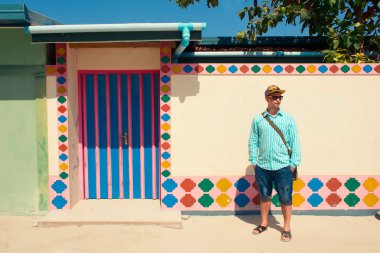 Mavi gömlek, sandalet giymiş genç esmer adam