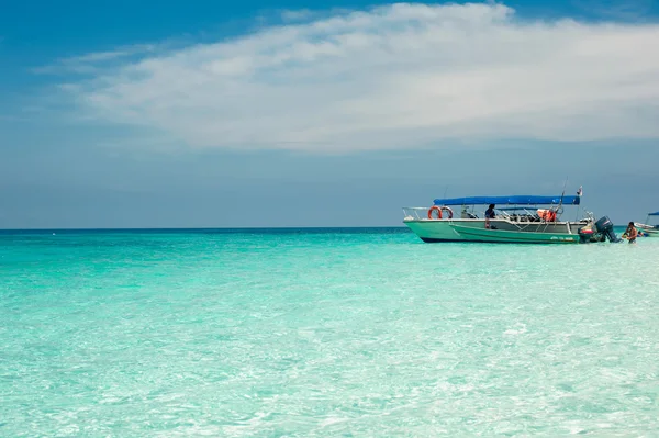 clear ocean maldives water under blue sky with boat