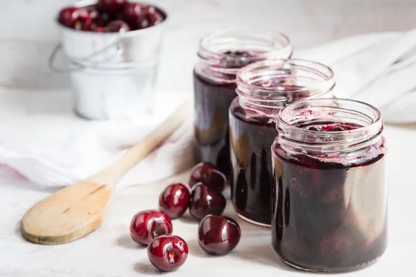 Jars with freshly homemade cherry jam — Stock Photo, Image