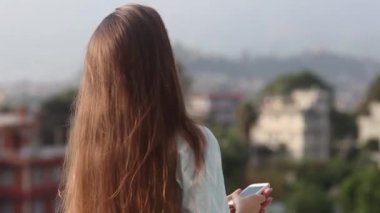 Güzel genç profesyonel kadın gün boyunca şehrin Office balkonda çatısında bir telefon görüşmesi vardır. O onun bel, gülen ve saç geliştirilmesi üzerinde bir rüzgar için ayağa kalkar. Katmandu, Nepal