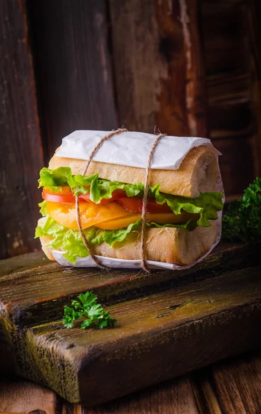 Sandwich avec salade de feuilles et tomates sur bassingraund en bois. Concentration sélective — Photo