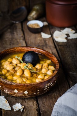 Chickpea spicy soup on wooden vintage background. Arabian food. Selective focus