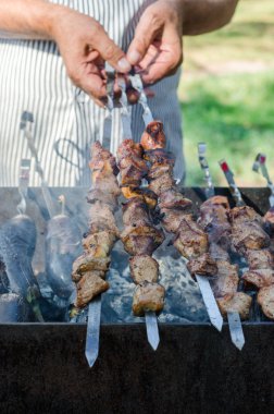 Adam yemek marine Şaşlık veya şiş kebap, tavuk eti üzerinde metal şiş ızgara, yakın çekim. Seçici odak