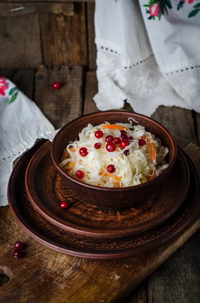 Sauerkraut with berries in clay bowl. Top wiev. Autumn concept — Stock Photo, Image