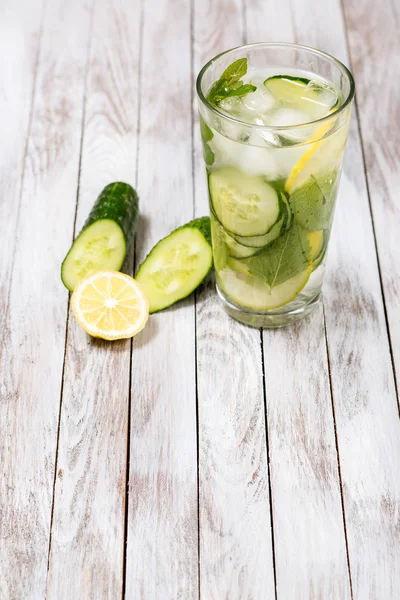 Water with lemon, mint and cucumber on wooden light background. Water Detox. — Stock Photo, Image