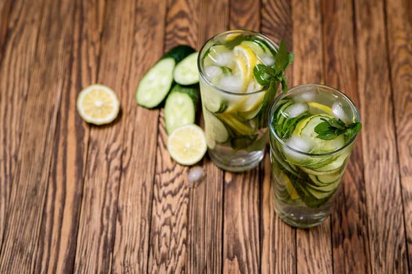 Water with lemon, mint and cucumber on wooden background. Water Detox. — Stock Photo, Image