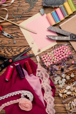 Ahşap arka plan, malzemeler ve araçlar üzerine yerleştirilmiş iğne işi için ayarlayın. Üstten Görünüm.