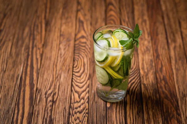 Water with lemon, mint and cucumber on wooden background. Water Detox. — Stock Photo, Image