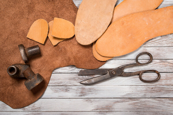 A lot of work tools and leather for shoemaker.Leather craft. Copy space.