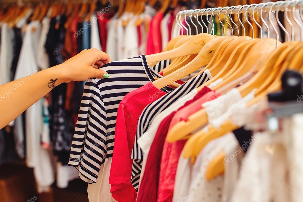 Clothes hangers with colorful clothes in a women shop. Summer sa Stock  Photo by ©Volurol 115457954