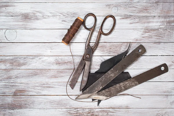 Conjunto de ferramentas para sapateiro sobre fundo de madeira branca. Espaço de cópia . — Fotografia de Stock