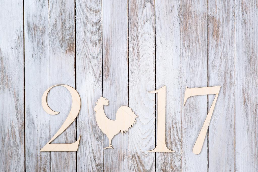 Happy New Year 2017 on wooden background.