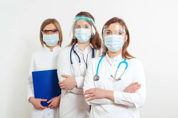 Medical staff wearing face shield and medical mask for protect coronavirus. Medicine, vaccination and healthcare. Hospital staff during quarantine. Group of doctors ready to fight coronavirus.
