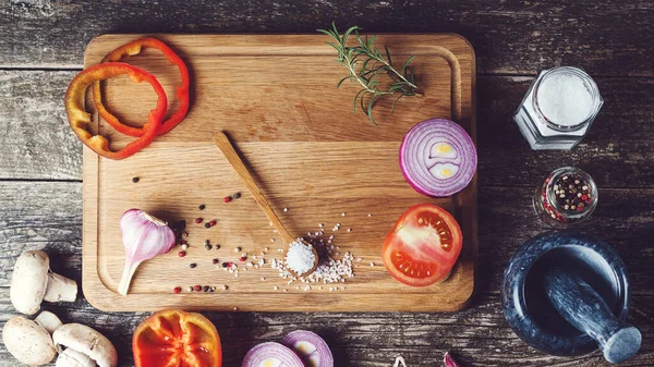 Spices and ingredients for cooking on wooden background. Healthy eating and cooking concept. Cooking background with different seasoning. Food background with copy space, top view.