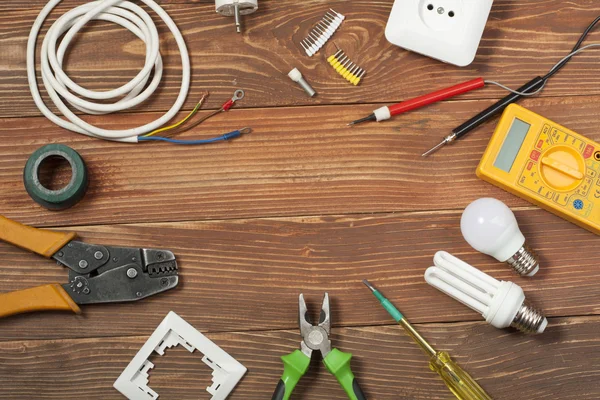 Set di utensili elettrici su sfondo in legno. Accessori per lavori di ingegneria, concetto di energia . — Foto Stock