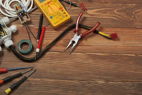 Juego de herramientas eléctricas sobre fondo de madera. Accesorios para trabajos de ingeniería, concepto energético . — Foto de Stock