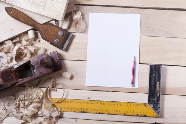 Construction tools on wooden table with sawdust. Joiner carpenter workplace top view. Copy space for text — Stock Photo, Image