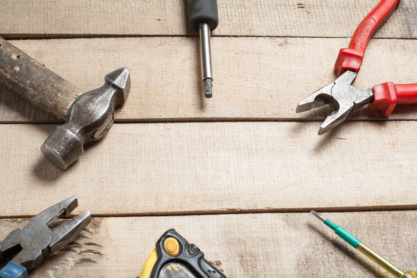 Construction tools on wooden background. Copy space for text. Set of assorted work tool at wood table . Top view